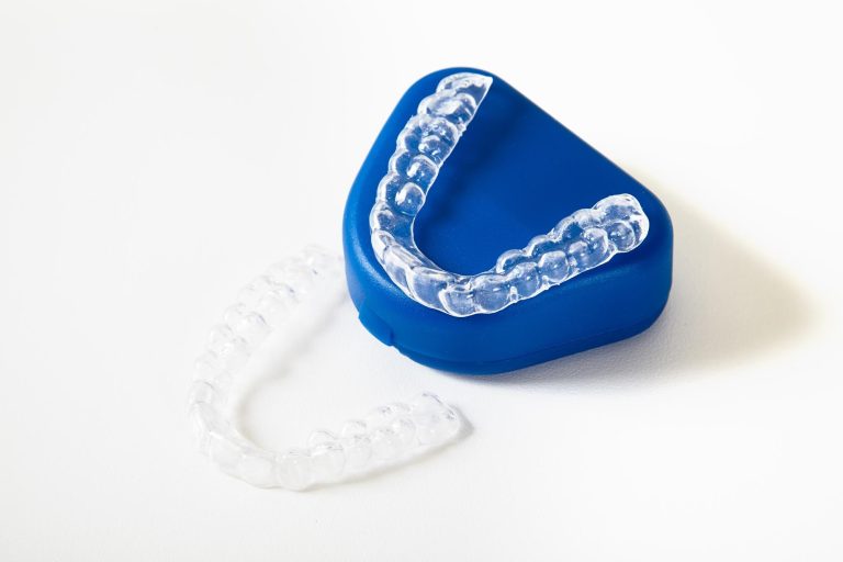 Clear dental mouth guard used to reduce snoring, shown with storage case