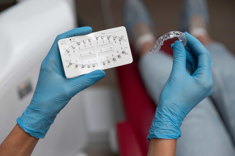Modern treatment option for straightening teeth shown through a clear aligner, contrasting with traditional braces used for crooked teeth.